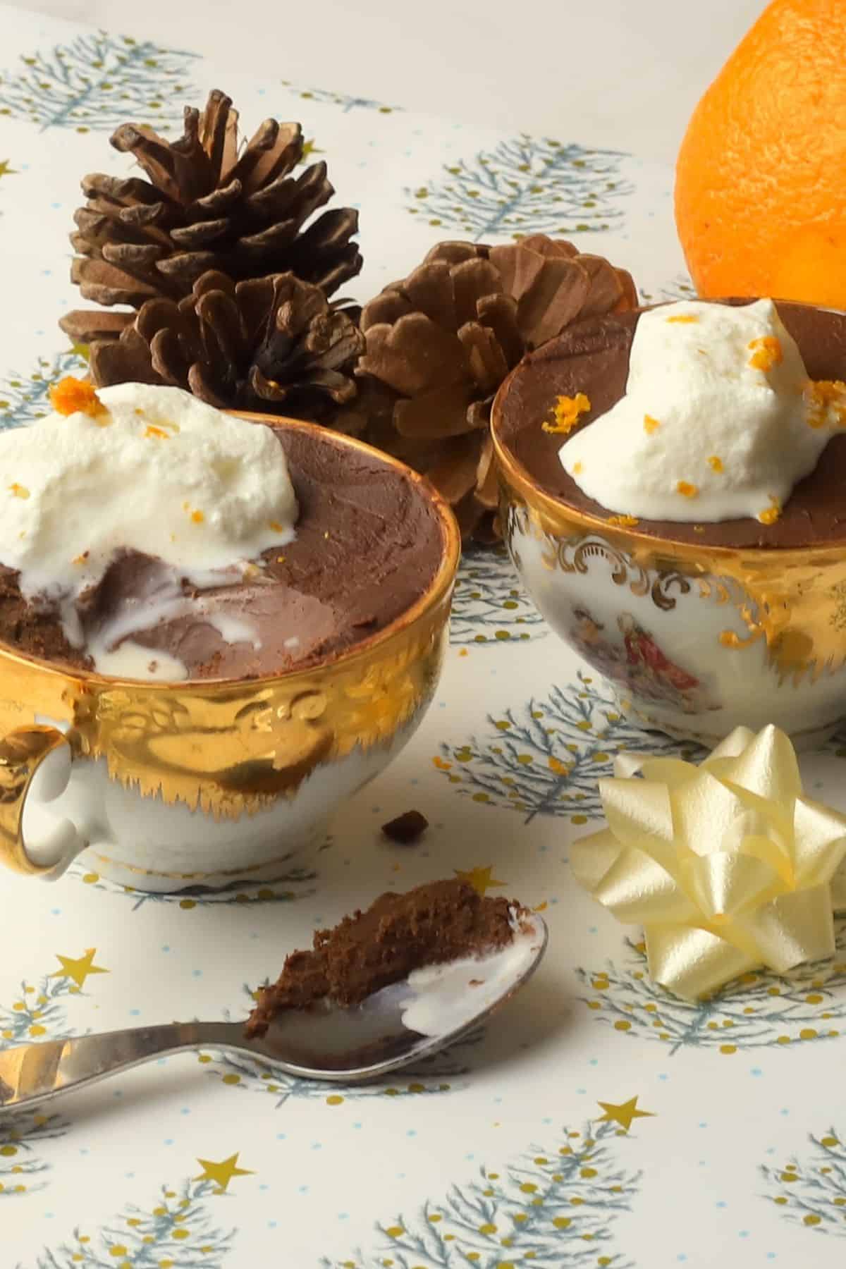 Sugar Free Orange chocolate pots in teacups next to acorns, and orange and a spoon.