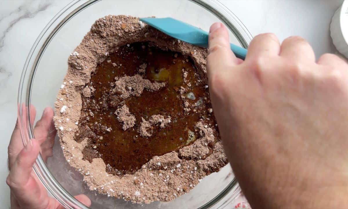 Mixing the wet and dry ingredients in a large bowl.