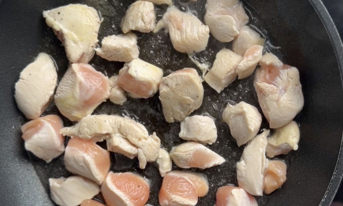 Browning the chicken in the skillet.