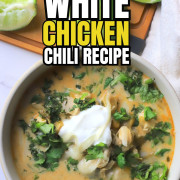 Overhead shot of a bowl with chicken chili topped with sour cream and cilantro.