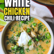 Overhead shot of a bowl with chicken chili topped with sour cream and cilantro.