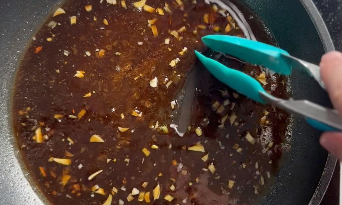 Stirring the sauce in the skillet.