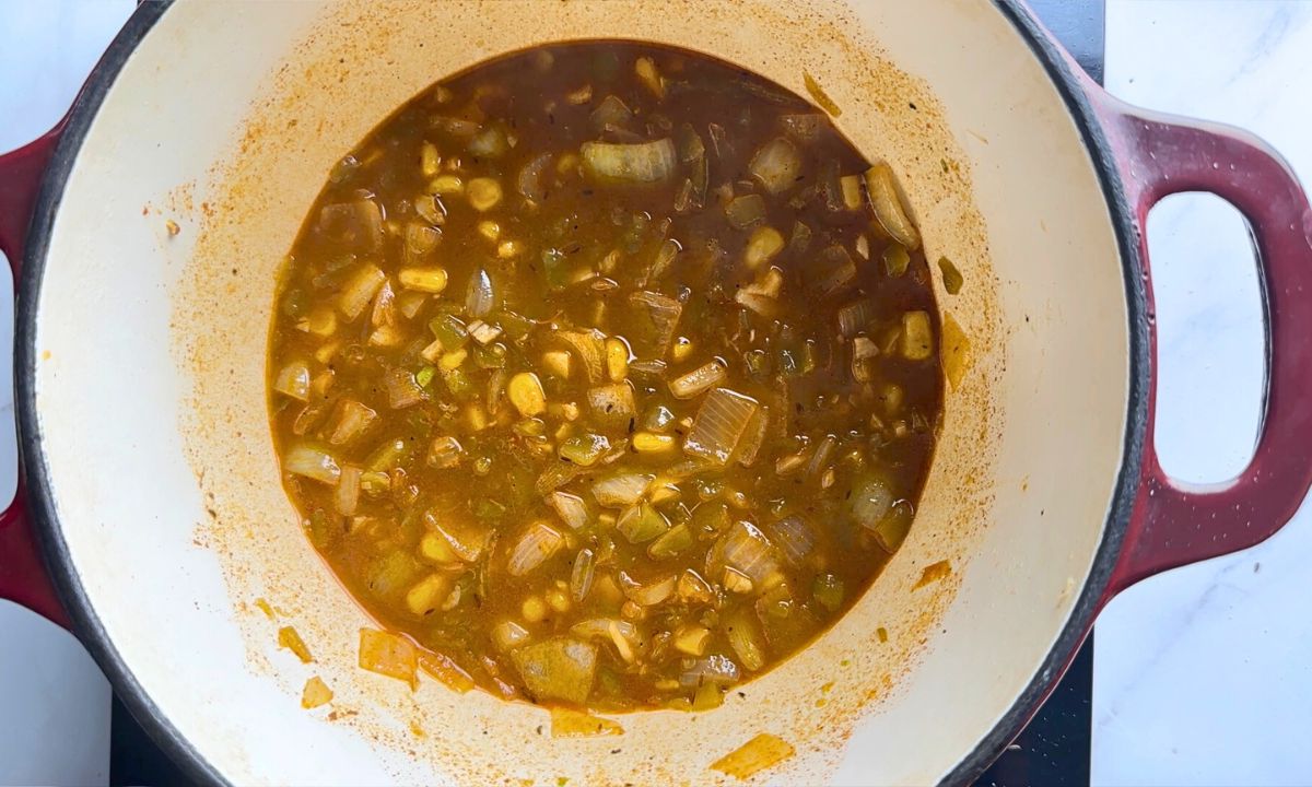 Large pot with ingredients and sauce.