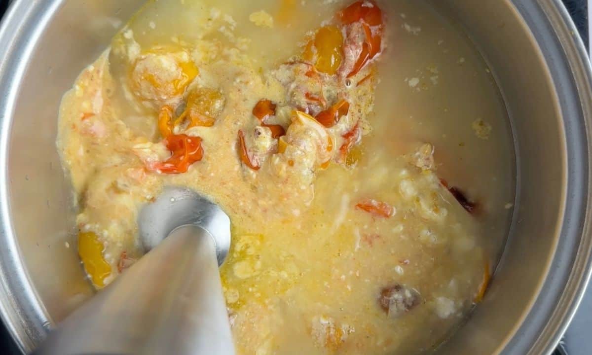 Blending the feta tomato mixture with the broth.
