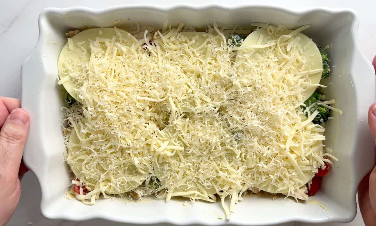 Casserole dish layered with the provolone cheese, mozzarella and grated parmesan.