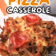 Low carb pizza casserole slice on a plate with the casserole in the background.