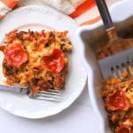 Low carb pizza casserole slice on a plate with the casserole next to it.