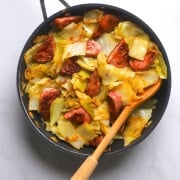 Cabbage and sausage in a skillet.