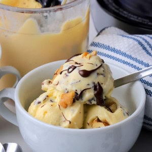 High protein chunky monkey ice cream in a bowl next to the ninja creami pint.