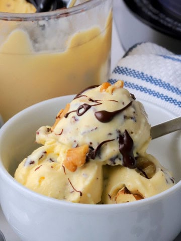 High protein chunky monkey ice cream in a bowl next to the ninja creami pint.