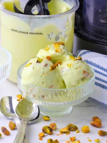 High protein sugar free pistacio ice cream made in the ninja creami in a bowl and in the creami pint.
