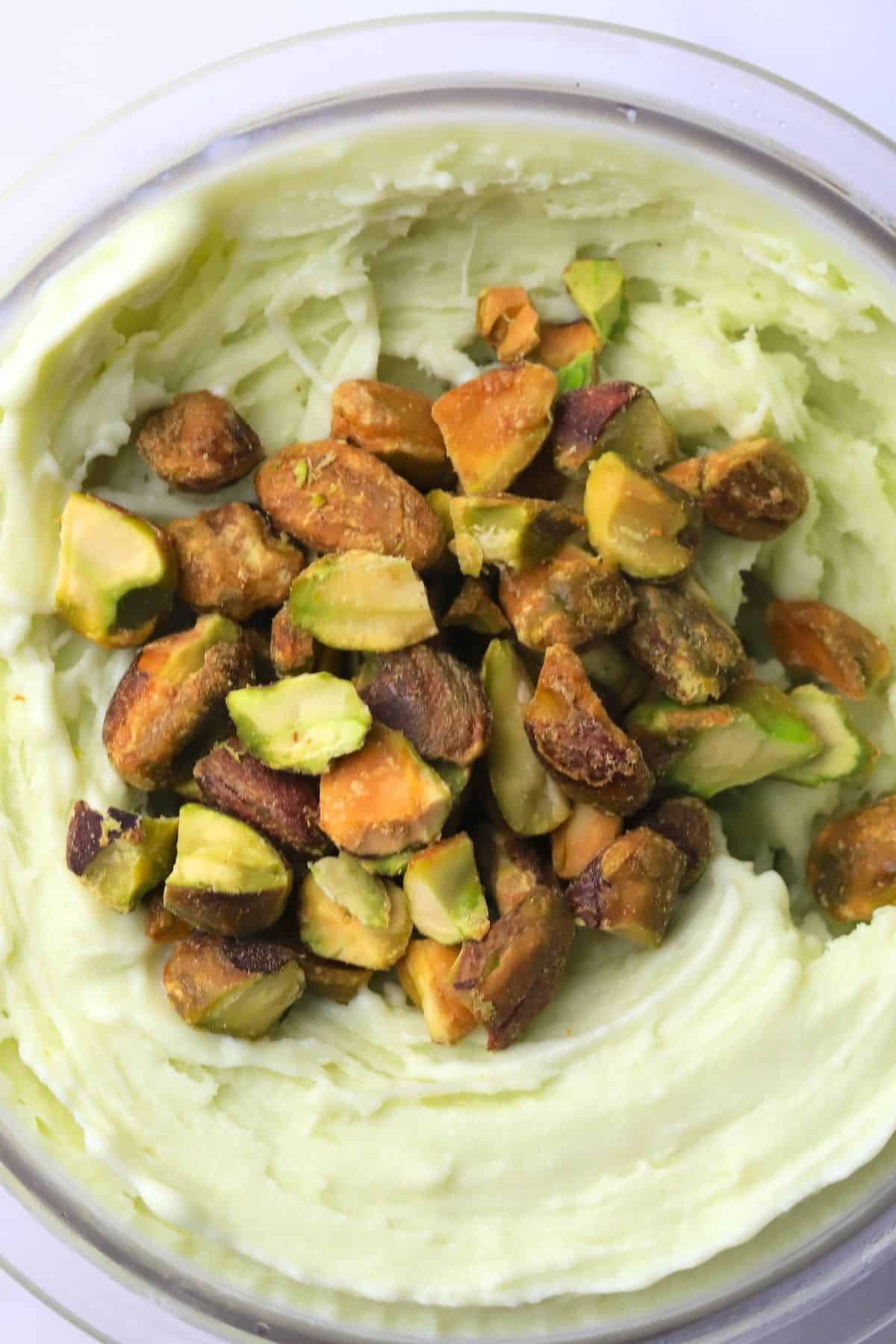 High protein sugar free pistachio ice cream in the ninja creami pint topped with pistachios
