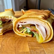 2 ingredient cottage cheese wrap on a cutting board rolled and sliced in half.