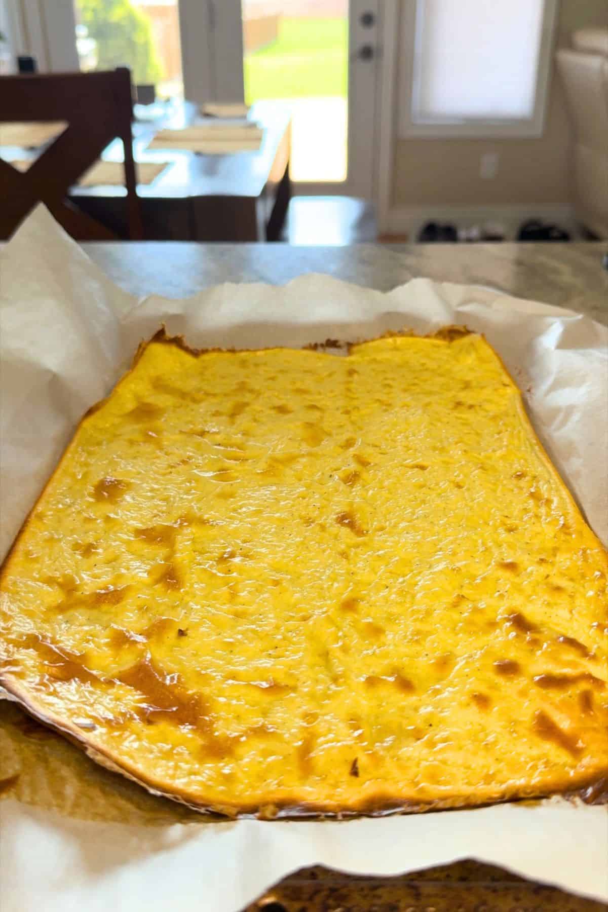 The full cottage cheese wrap on a parchment lined baking sheet.
