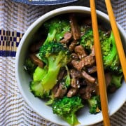 Low carb beef and broccoli in a bowl with chopsticks.