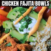 Low carb chicken fajita bowl filled with chicken, peppers, black beans, tomatoes, cauliflower rice and an avocado.