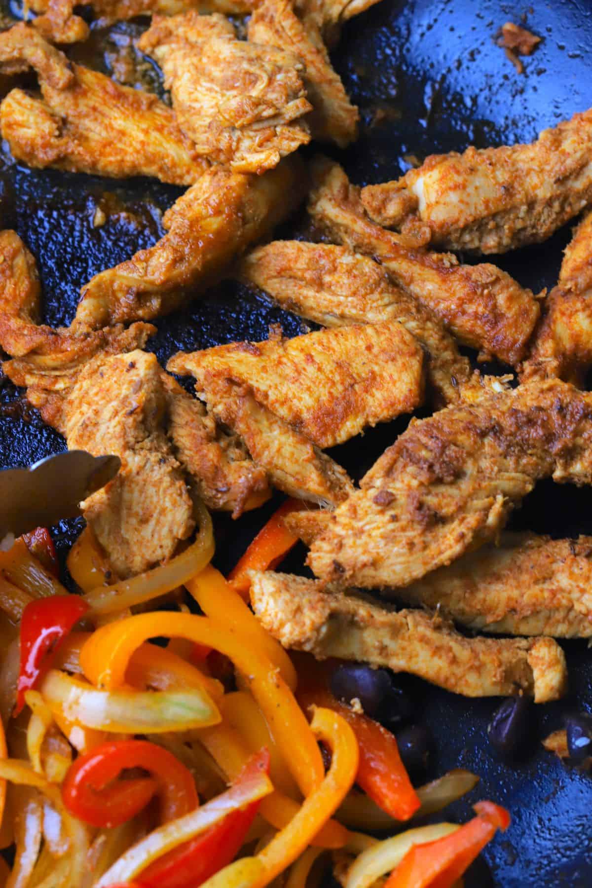 Skillet with peppers, onions and chicken.