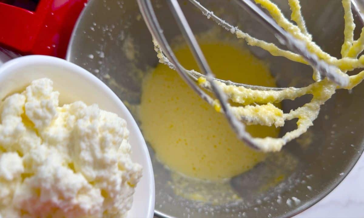 Adding ricotta to the mixer.