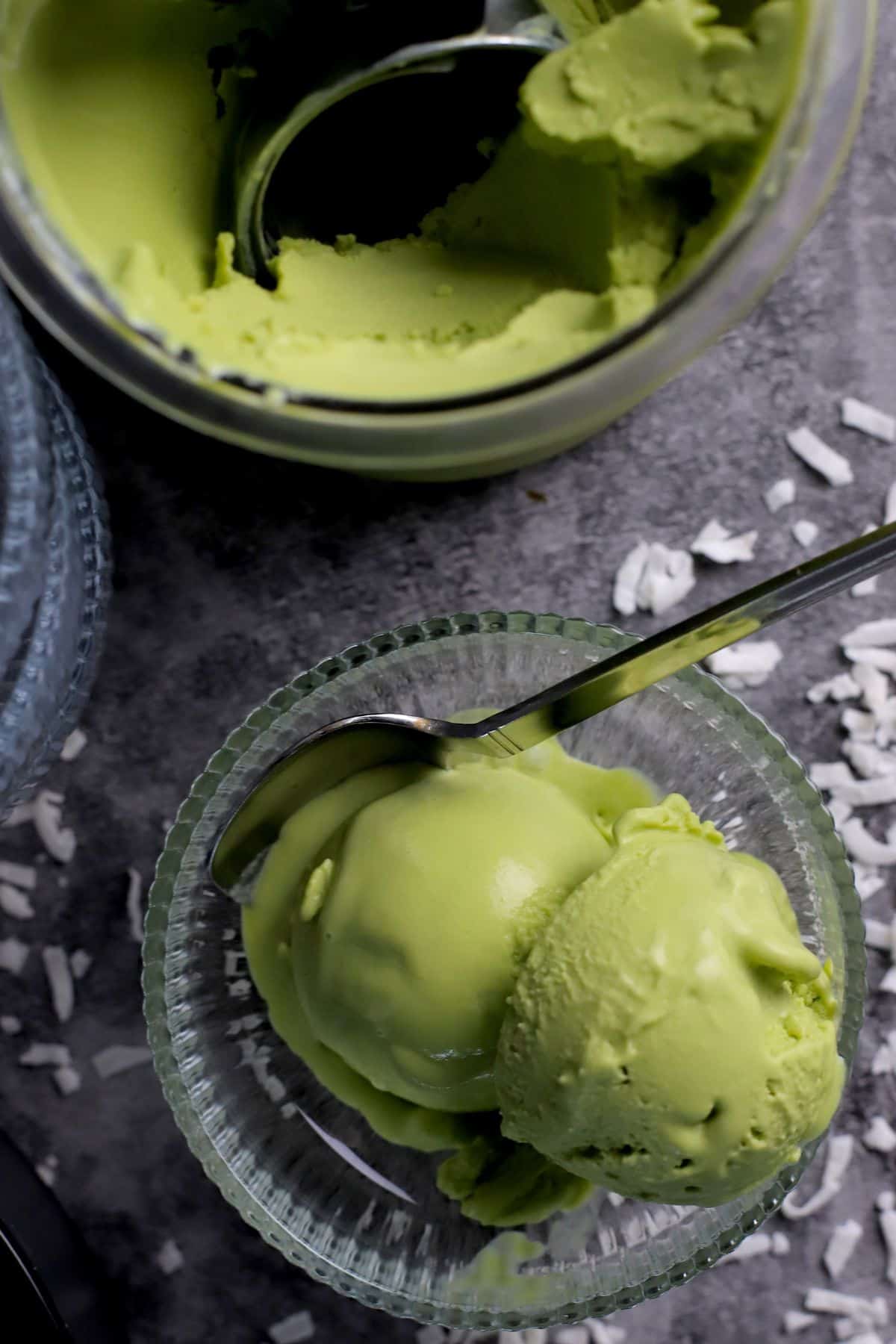 Bowl and pint of vegan coconut match ice cream made in the ninja creami.