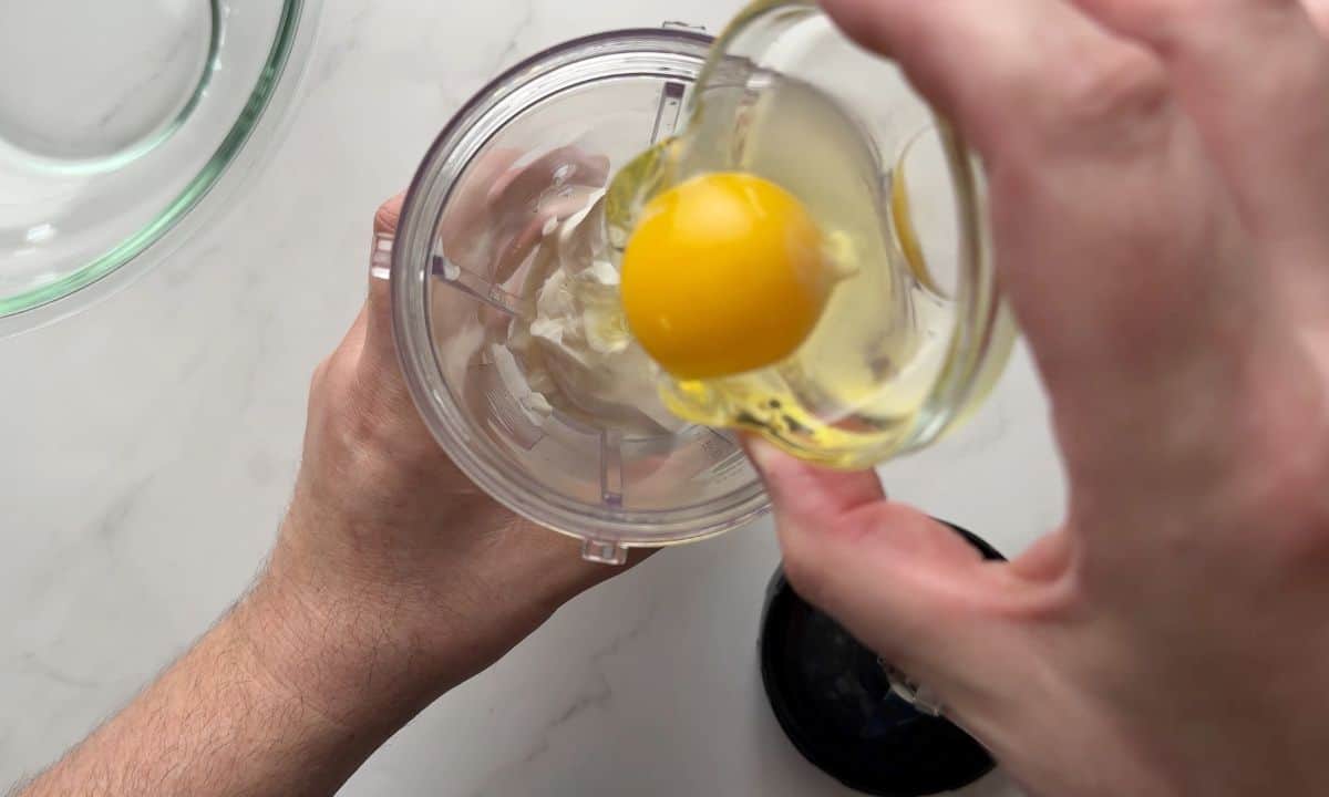 Adding the egg to the blender.