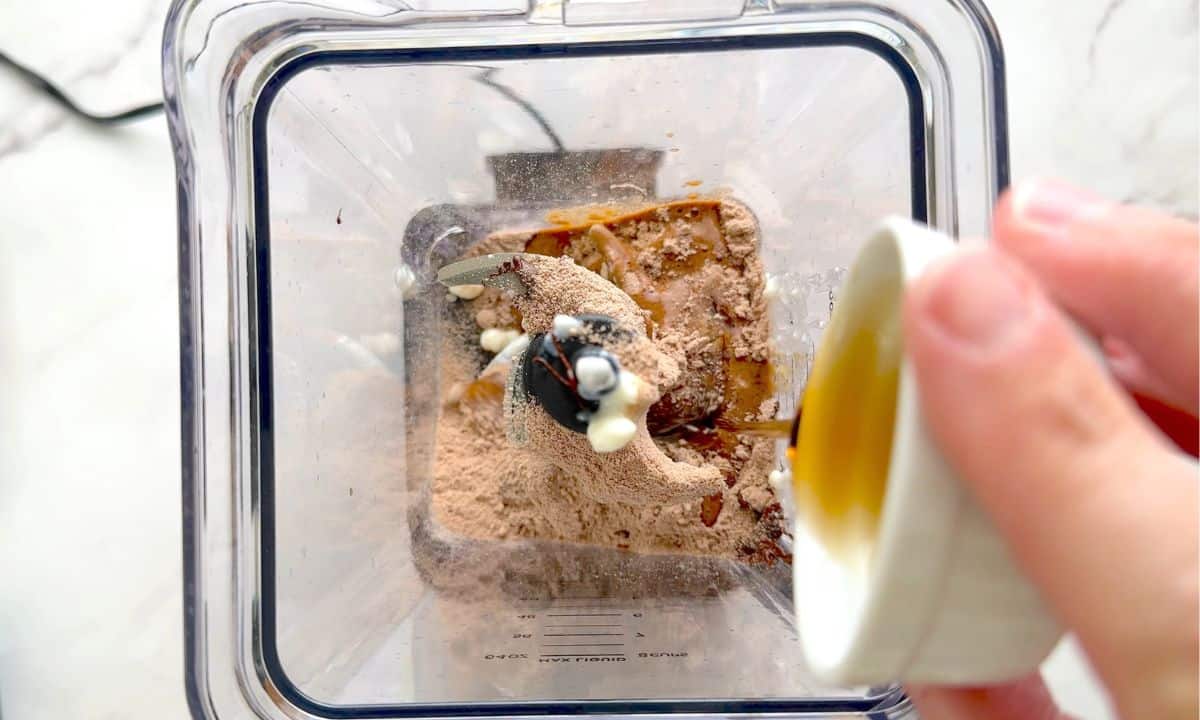 Adding ingredients to the blender.