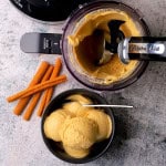 Chickpea cinnamon ice cream in a bowl next to the ninja creami pint.