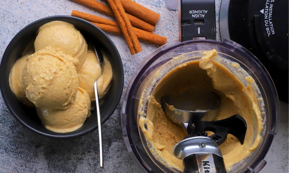 Chickpea cinnamon ice cream in a bowl next to the ninja creami pint.
