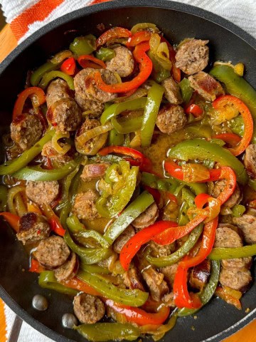 Sausage and peppers in a skillet.