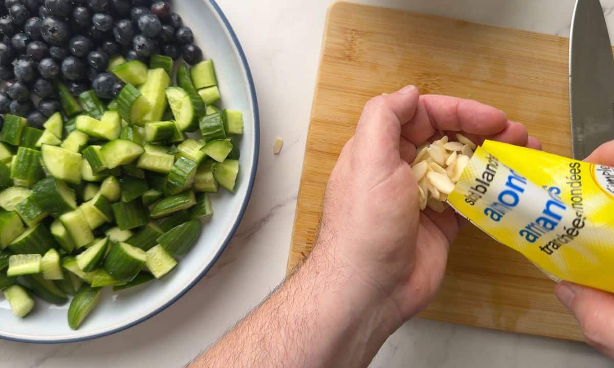 Adding the slivered almonds to the salad.