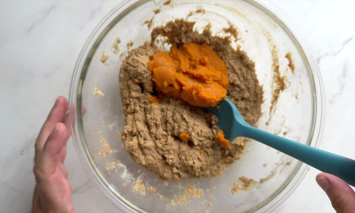 Adding the pumpkin puree to the wet ingredients.