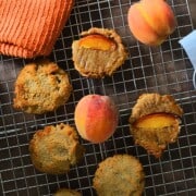 Low carb peach upside down cookies on a cooling rack with peaches.