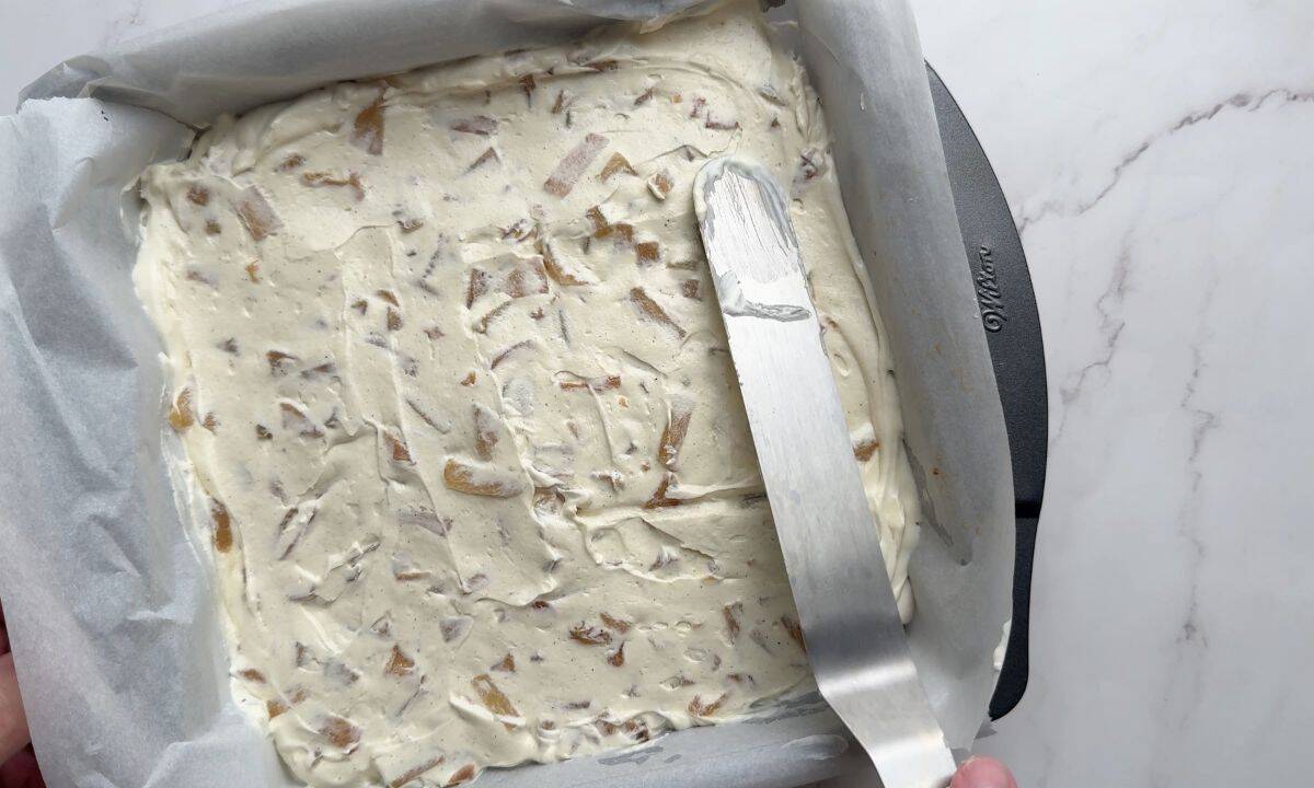 Spreading the apple layer into the pan.