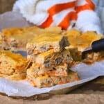Cottage cheese carrot cake bars stacked on top of each other.