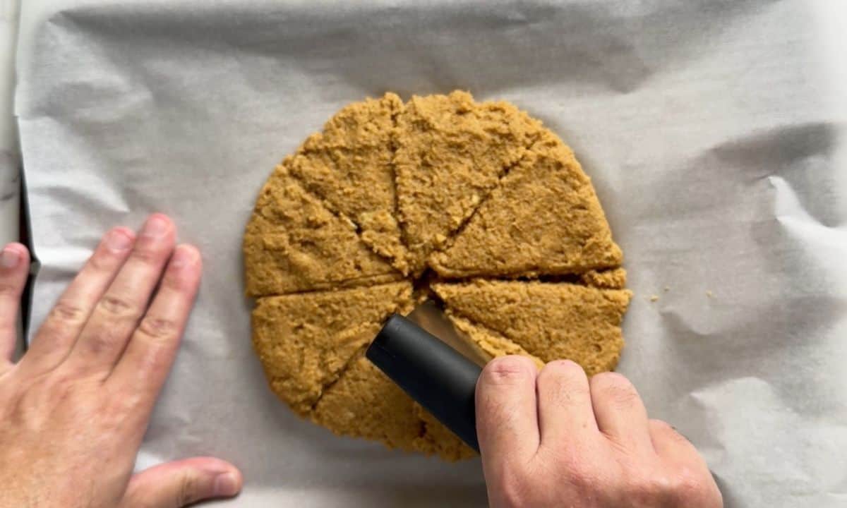 Cutting the scones into triangles on the cookie tray.