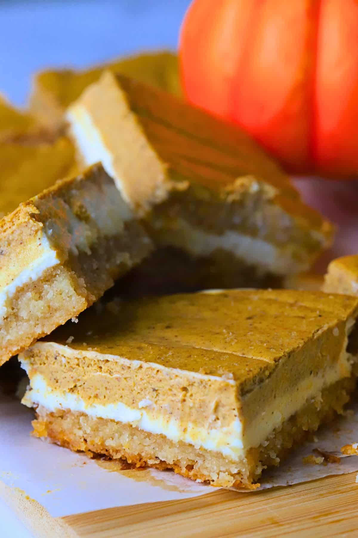 Low carb pumpkin spice cheesecake bars on a cutting a board.
