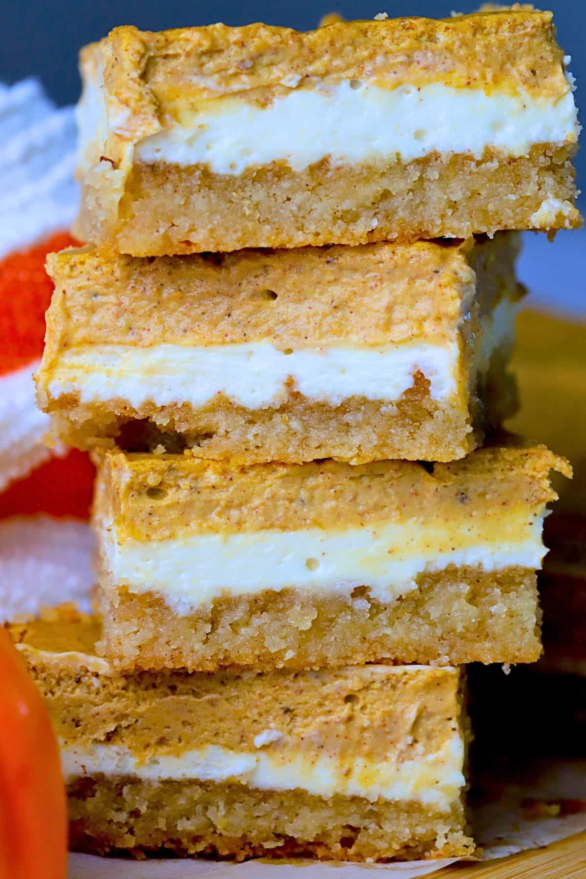 Low carb pumpkin spice cheesecake bars stacked on top of each other.