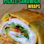 Low carb viral pickle sandwich wrap on a cutting board.