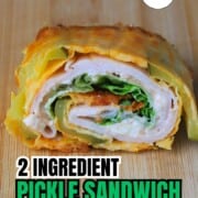 Low carb viral pickle sandwich wrap on a cutting board.