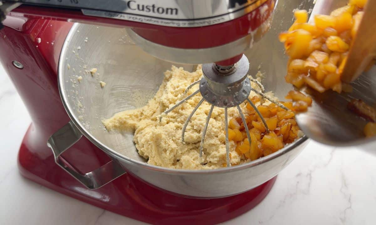 Adding the diced apples to the mixer.