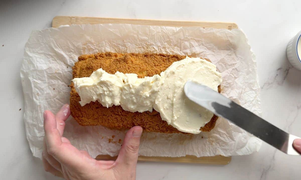 Frosting the low carb orange loaf cake.