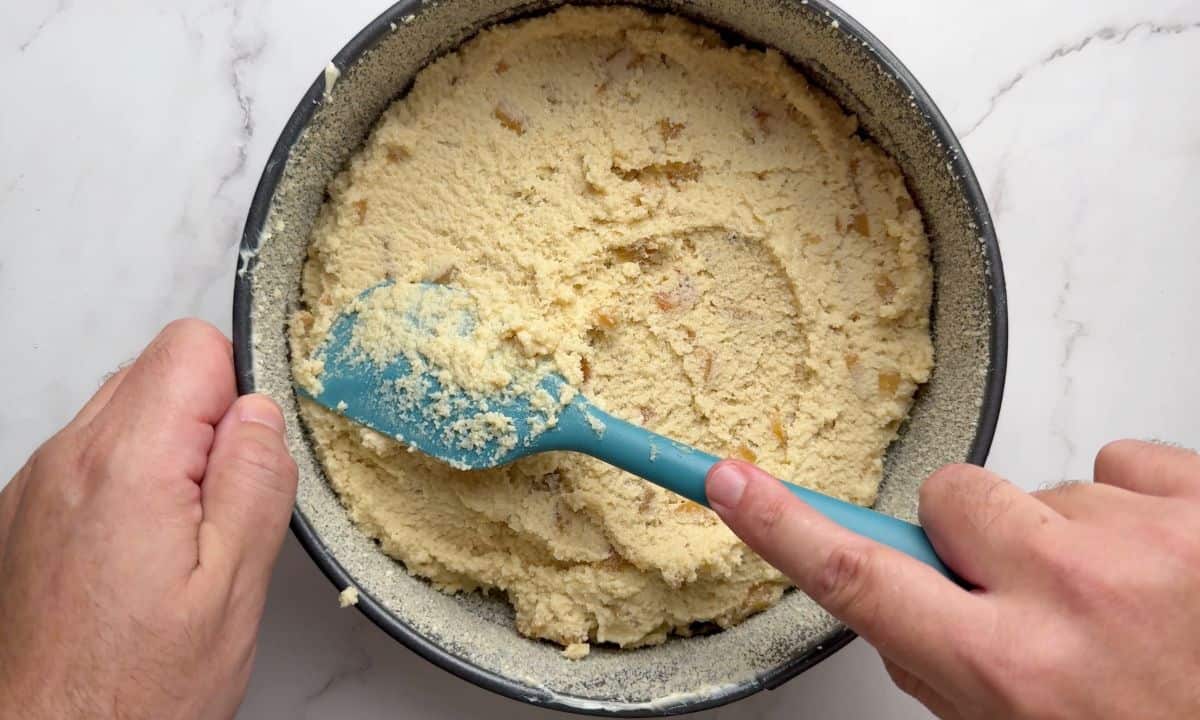 Smoothing out the cake batter in the pan.
