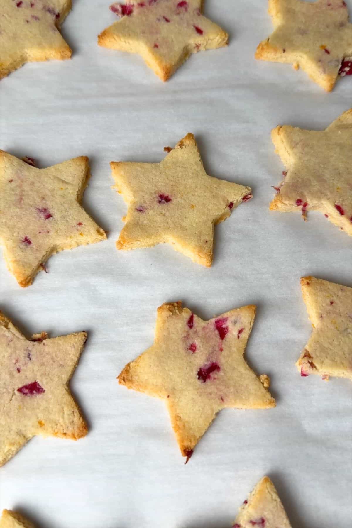 Baked low carb orange cranberry shortbread cookies on a baking sheet.