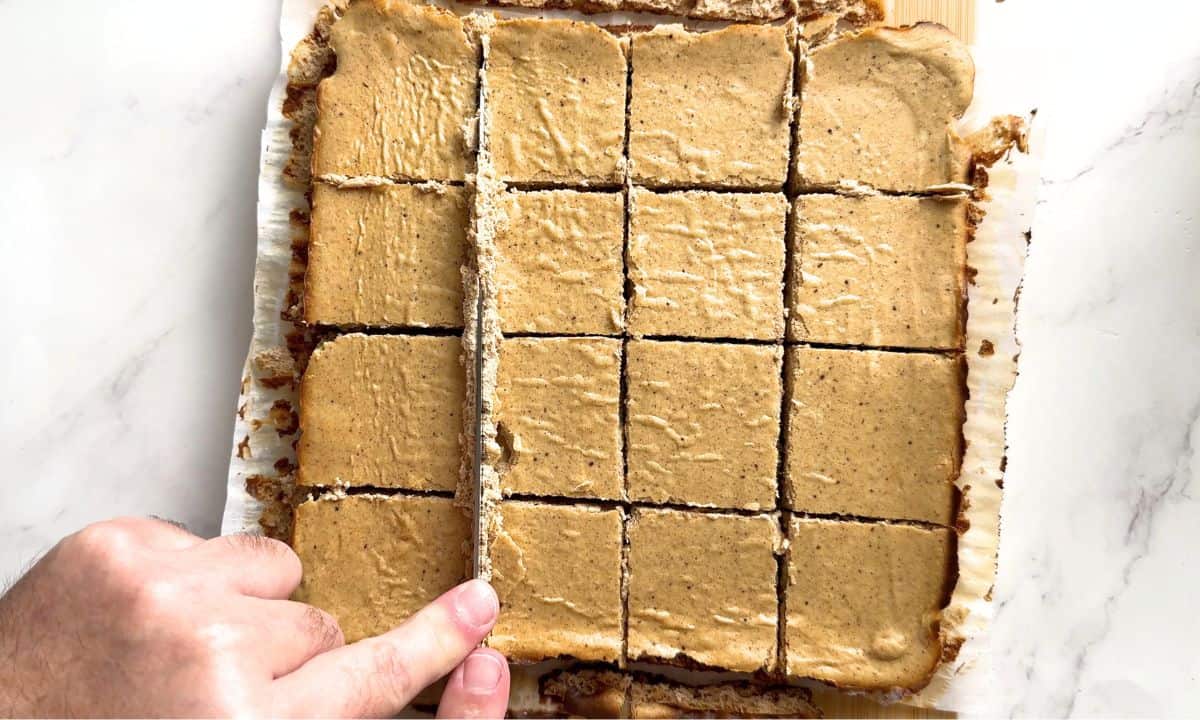 Cutting the cheesecake into bars.
