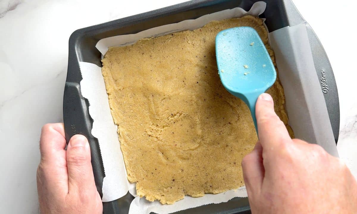Spreading out the crust in the baking pan.
