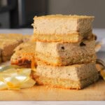 Low carb gingerbread cheesecake squares stacked on top of each other.