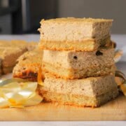 Low carb gingerbread cheesecake squares stacked on top of each other.