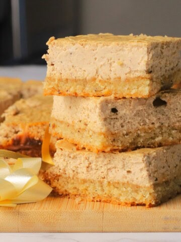 Low carb gingerbread cheesecake squares stacked on top of each other.