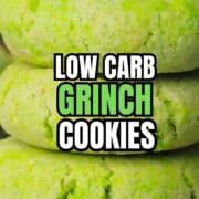 Low carb grinch cookies stacked on a cooling rack.