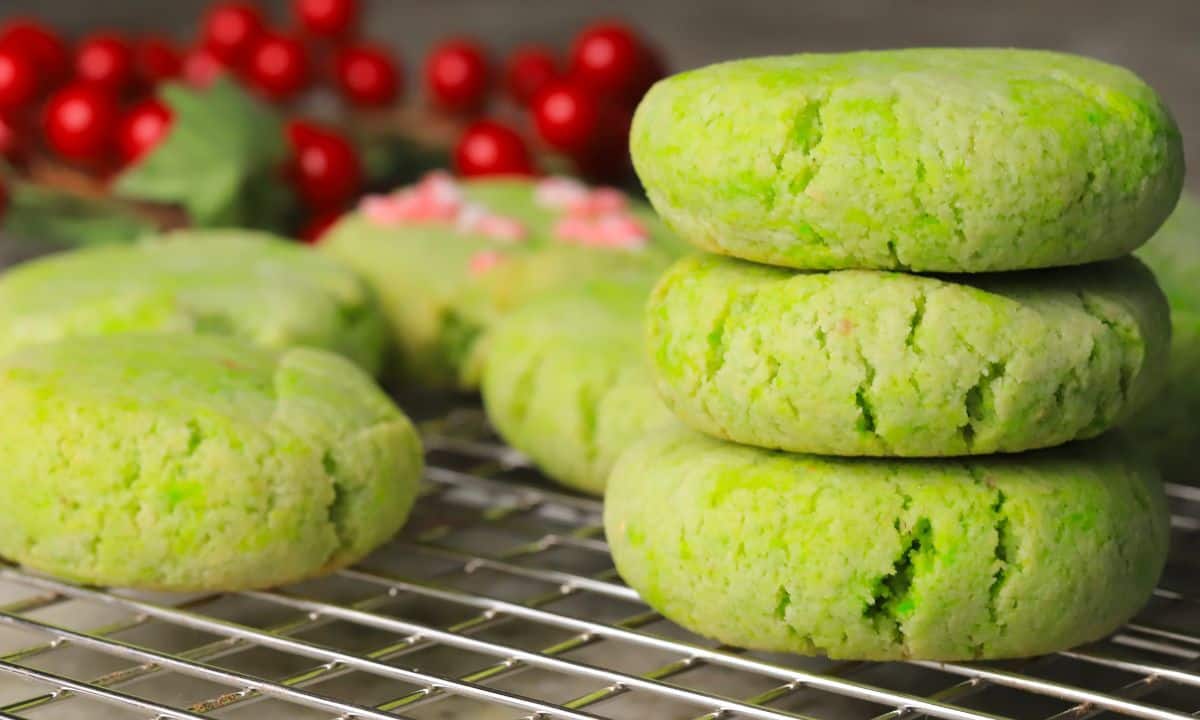 Low carb grinch cookies stacked on a cooling rack.