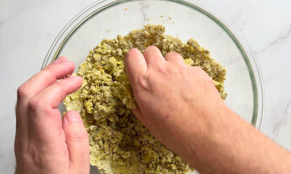 Hand in a bowl of the dry ingredients.